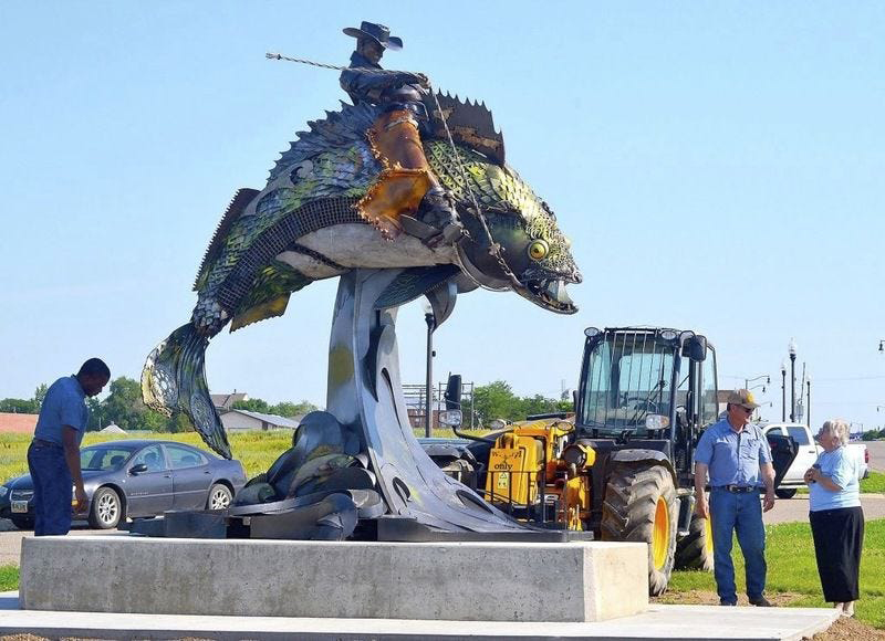 Cowboy Riding Fish Statue