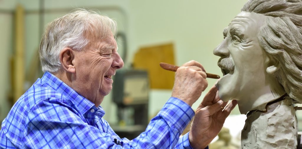 Artist handcrafting a portrait sculpture